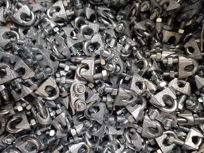 Assorted wire rope clips on a workbench
