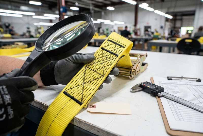 A quality inspection showing the dense stitching on a ratchet strap