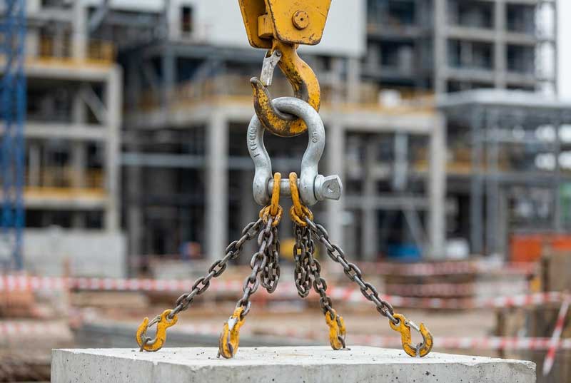 A bow shackle connecting a multi-leg sling to a crane hook